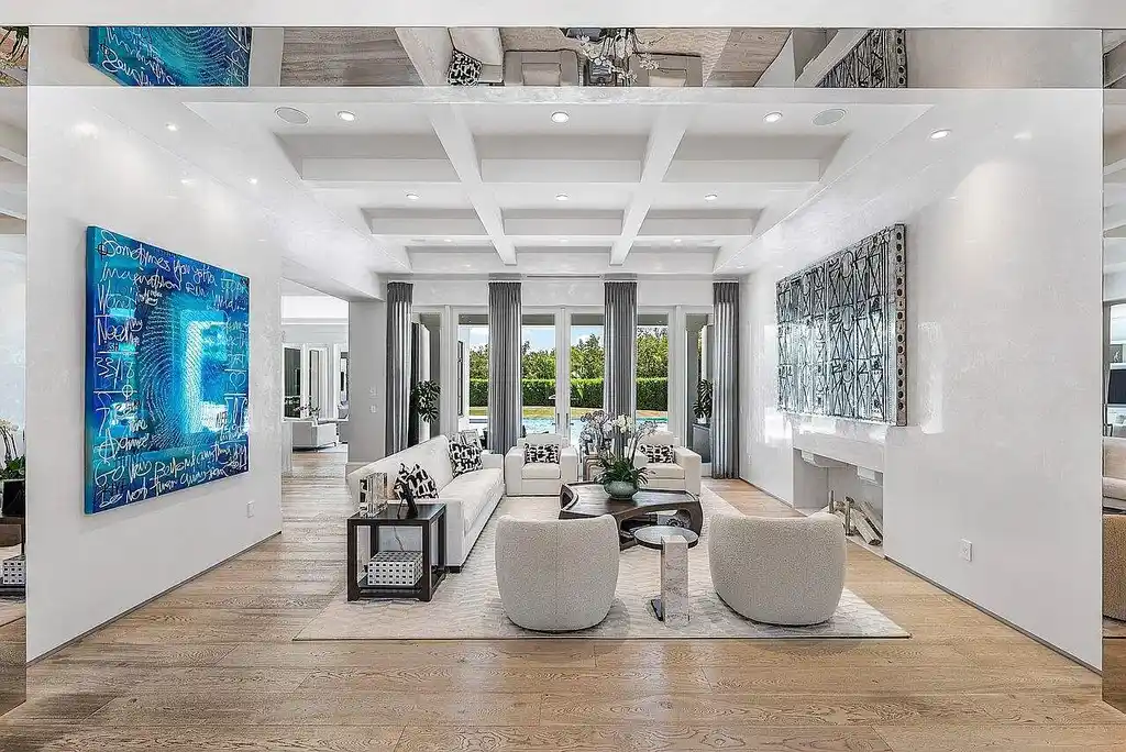 Luxury estate at 1162 Banyan Estates Drive with infinity pool, tropical landscape, and modern design in gated Seminole Landing, North Palm Beach, FL.