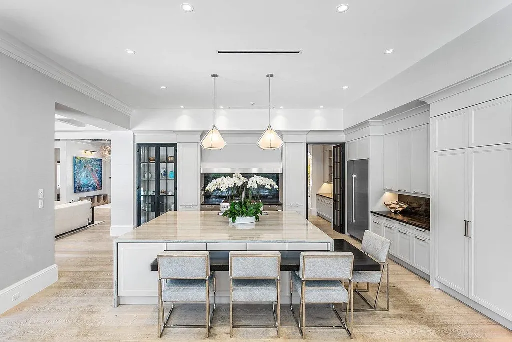 Luxury estate at 1162 Banyan Estates Drive with infinity pool, tropical landscape, and modern design in gated Seminole Landing, North Palm Beach, FL.