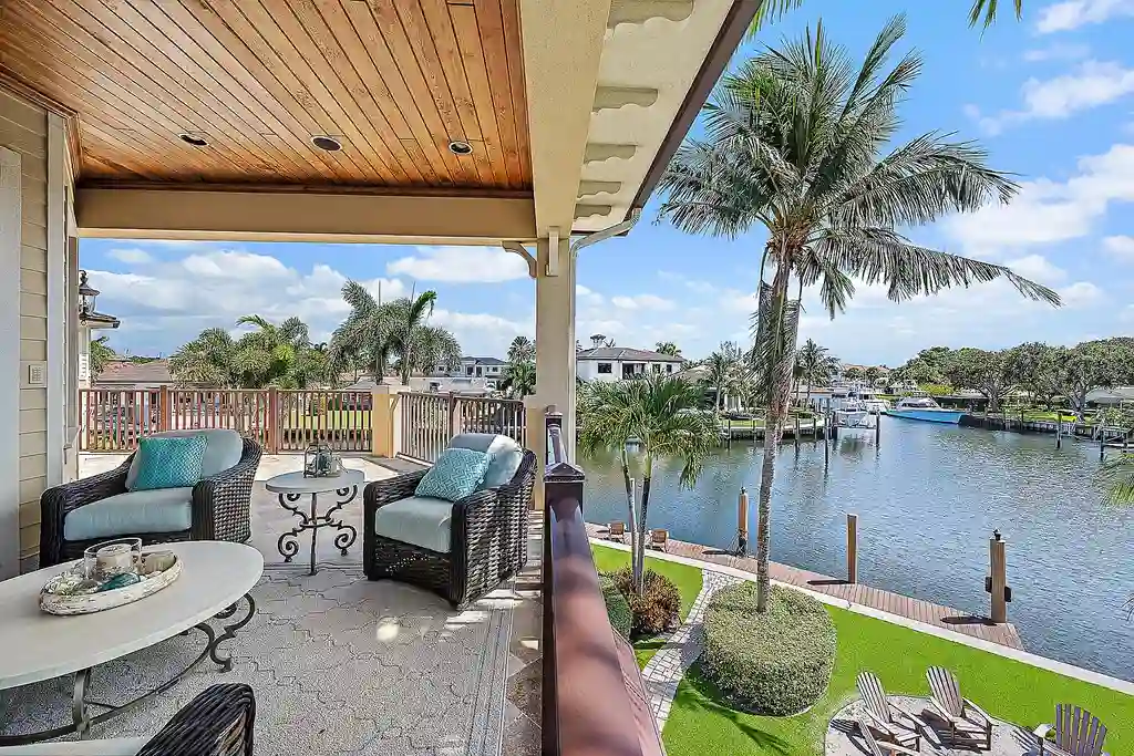 Aerial view of 2365 Azure Circle showing saltwater pool, waterfront dock, and lush landscaping in Palm Beach Gardens Real Estate