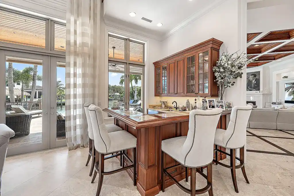 Aerial view of 2365 Azure Circle showing saltwater pool, waterfront dock, and lush landscaping in Palm Beach Gardens Real Estate