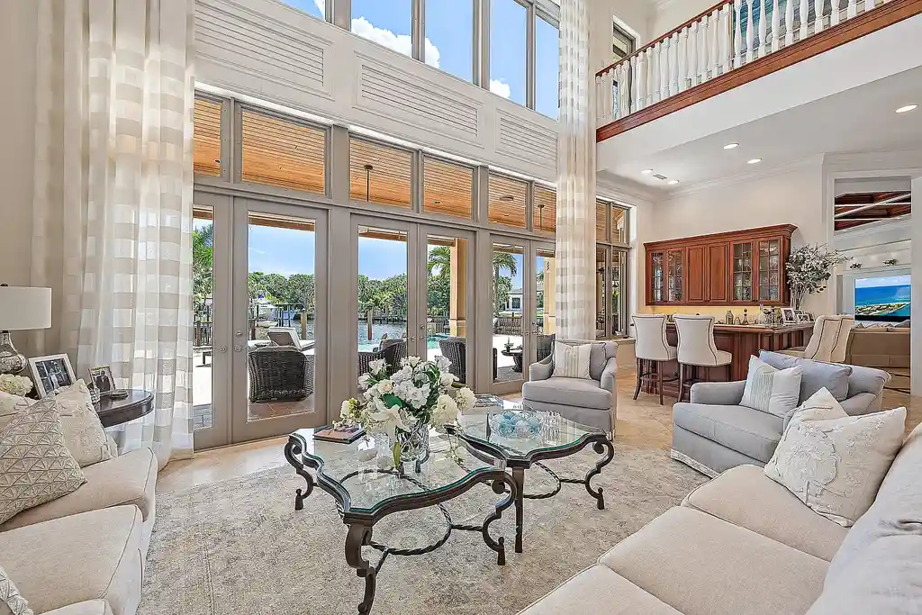 Aerial view of 2365 Azure Circle showing saltwater pool, waterfront dock, and lush landscaping in Palm Beach Gardens Real Estate