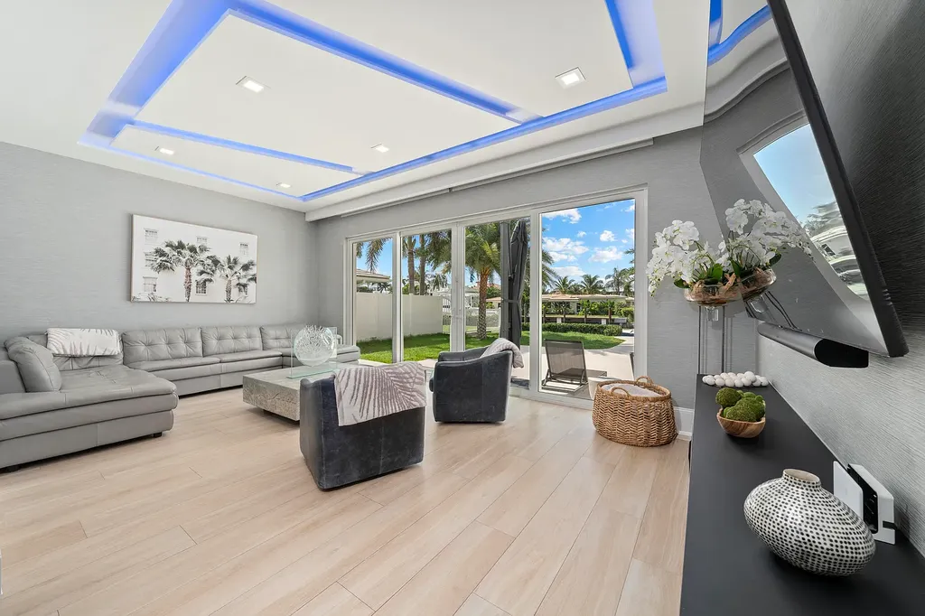 Front exterior of 2900 NE 23 Place Pompano Beach with lush landscaping and circular driveway