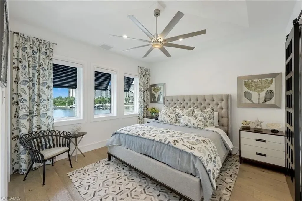Infinity-edge saltwater pool and private dock at luxury home in Naples for sale, located on Venetian Bay with waterfront views.