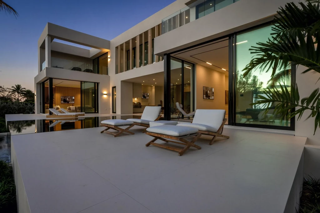 Modern waterfront home at 35 Spoonbill Road Manalapan with white-oak fins and sculptural architecture