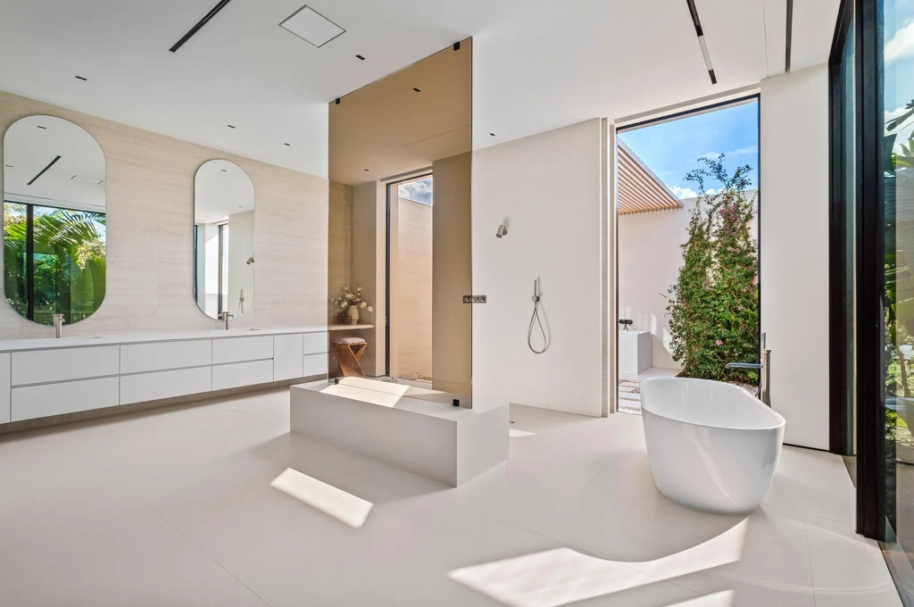 Modern waterfront home at 35 Spoonbill Road Manalapan with white-oak fins and sculptural architecture