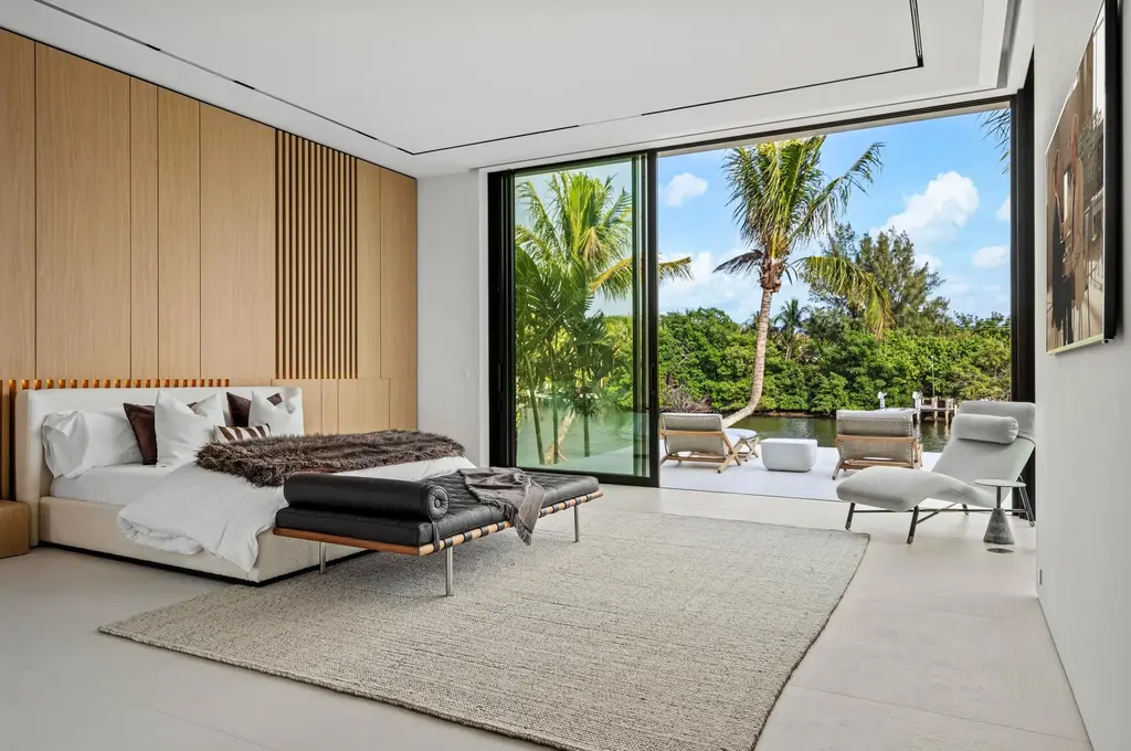 Modern waterfront home at 35 Spoonbill Road Manalapan with white-oak fins and sculptural architecture