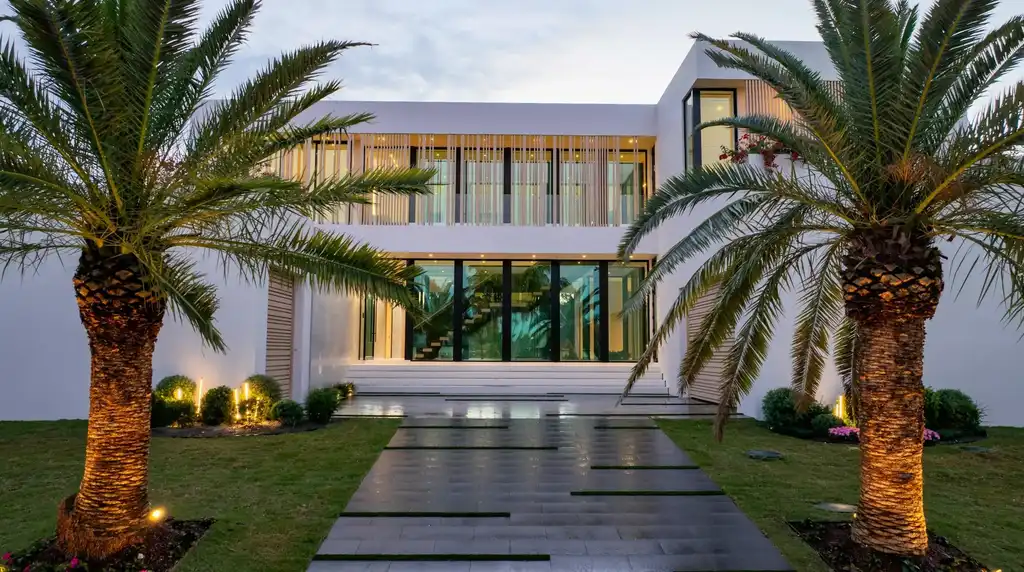 Modern waterfront home at 35 Spoonbill Road Manalapan with white-oak fins and sculptural architecture