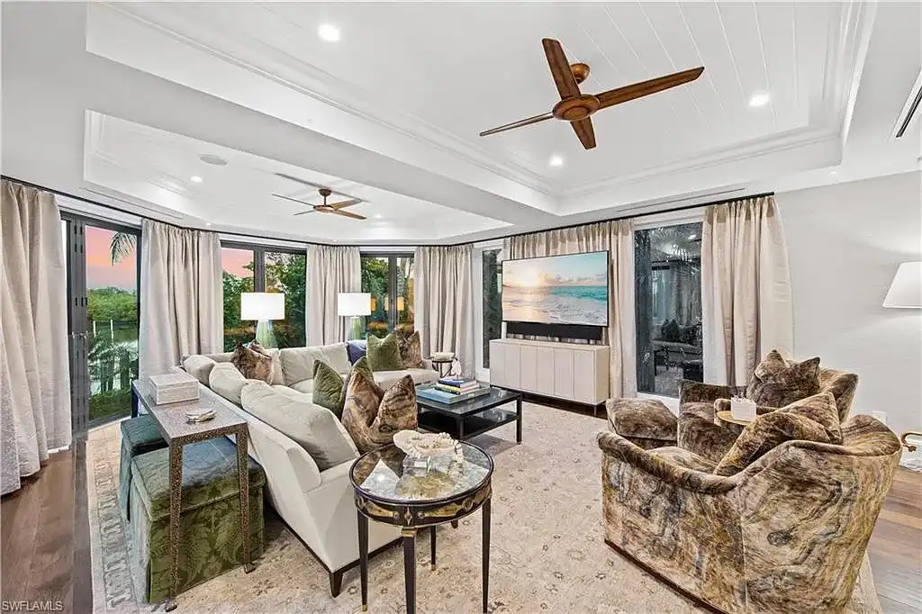 3675 Gordon Dr luxury home in Naples featuring French West Indies design, private beach access, koi pond, resort-style pool, and Gulf-access dock.