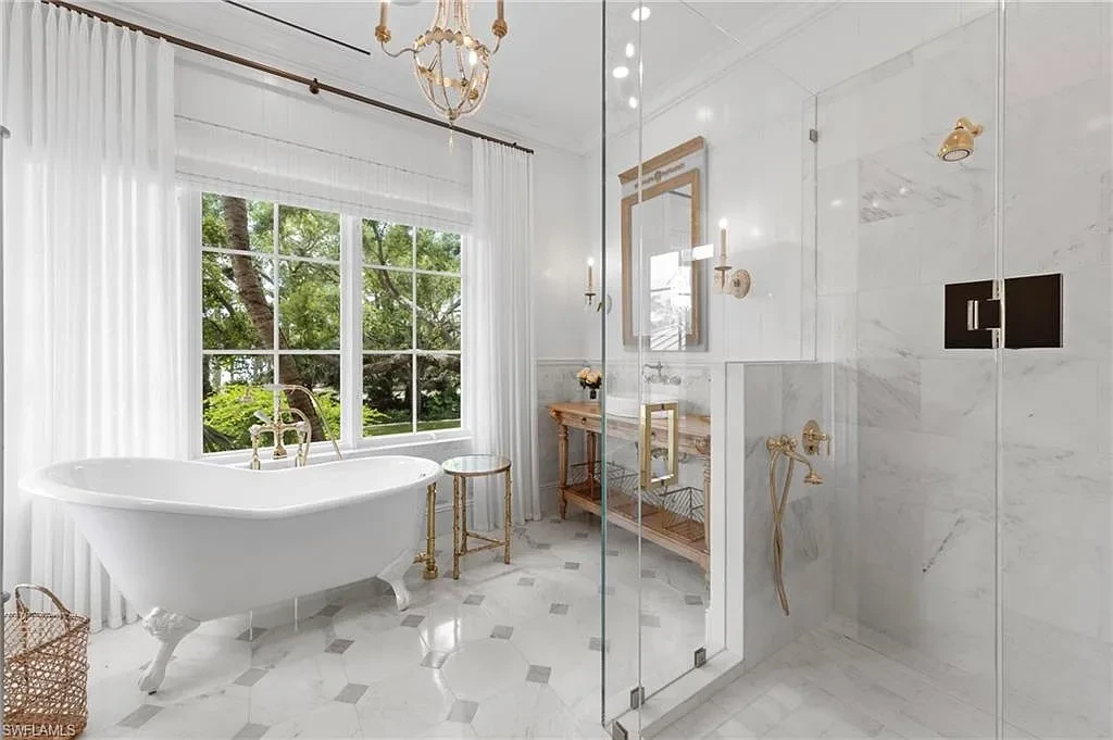 3675 Gordon Dr luxury home in Naples featuring French West Indies design, private beach access, koi pond, resort-style pool, and Gulf-access dock.