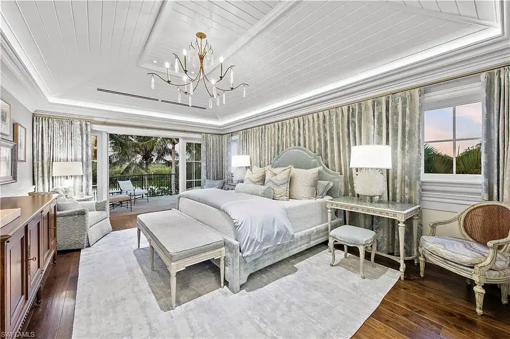 3675 Gordon Dr luxury home in Naples featuring French West Indies design, private beach access, koi pond, resort-style pool, and Gulf-access dock.