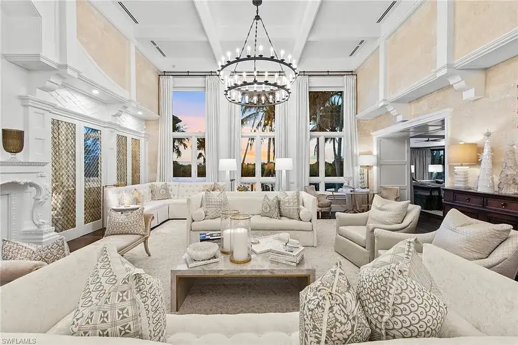 3675 Gordon Dr luxury home in Naples featuring French West Indies design, private beach access, koi pond, resort-style pool, and Gulf-access dock.
