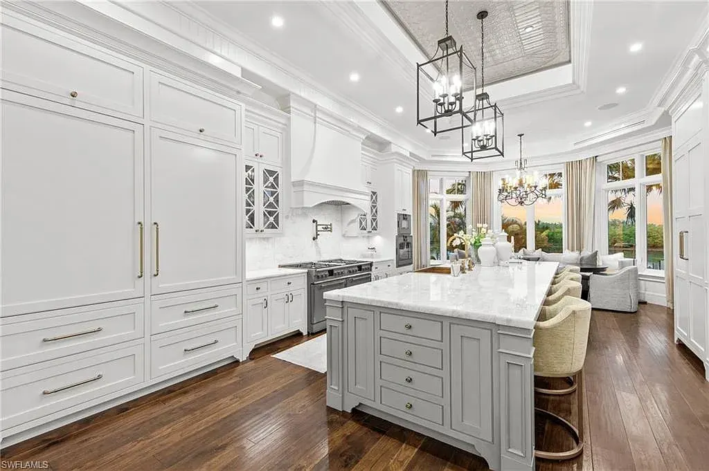 3675 Gordon Dr luxury home in Naples featuring French West Indies design, private beach access, koi pond, resort-style pool, and Gulf-access dock.