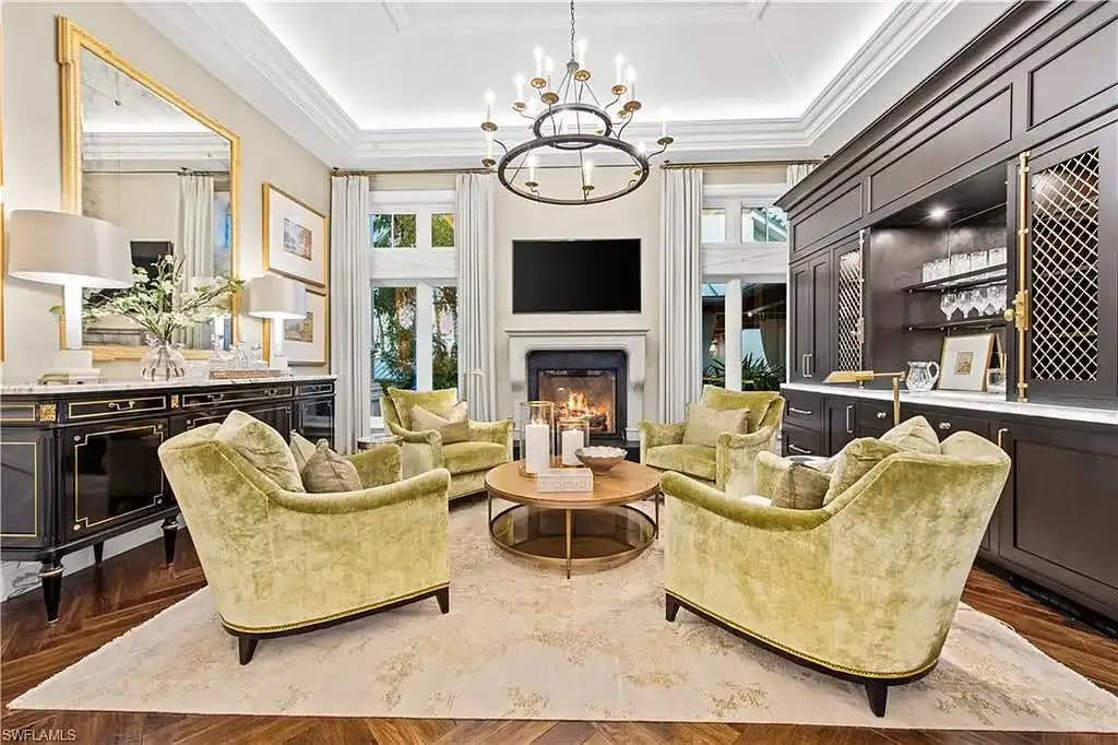 3675 Gordon Dr luxury home in Naples featuring French West Indies design, private beach access, koi pond, resort-style pool, and Gulf-access dock.