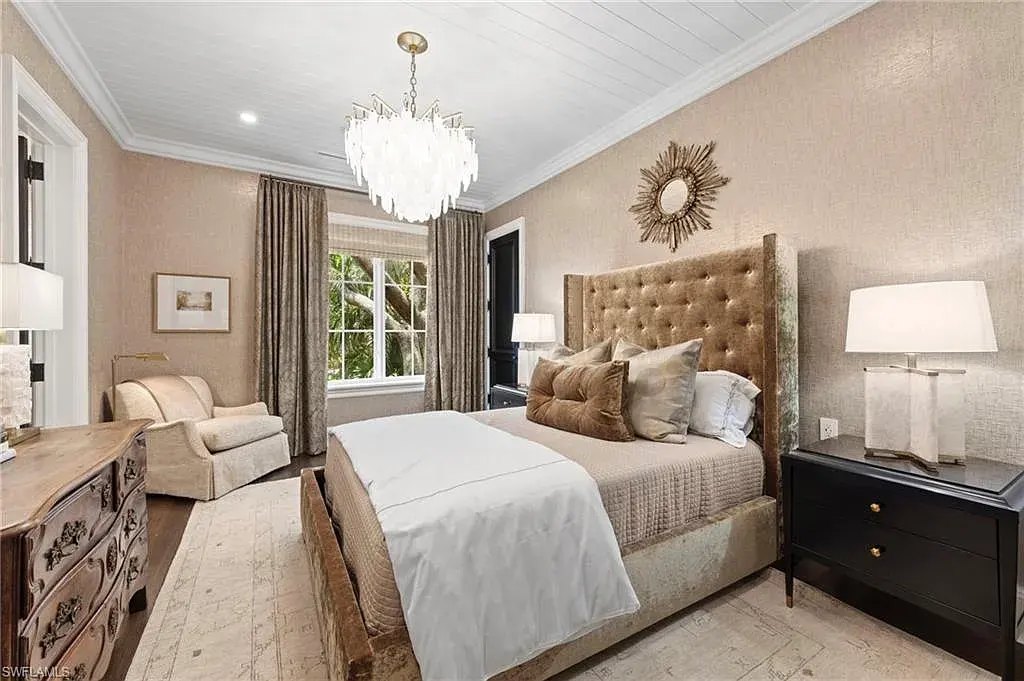 3675 Gordon Dr luxury home in Naples featuring French West Indies design, private beach access, koi pond, resort-style pool, and Gulf-access dock.