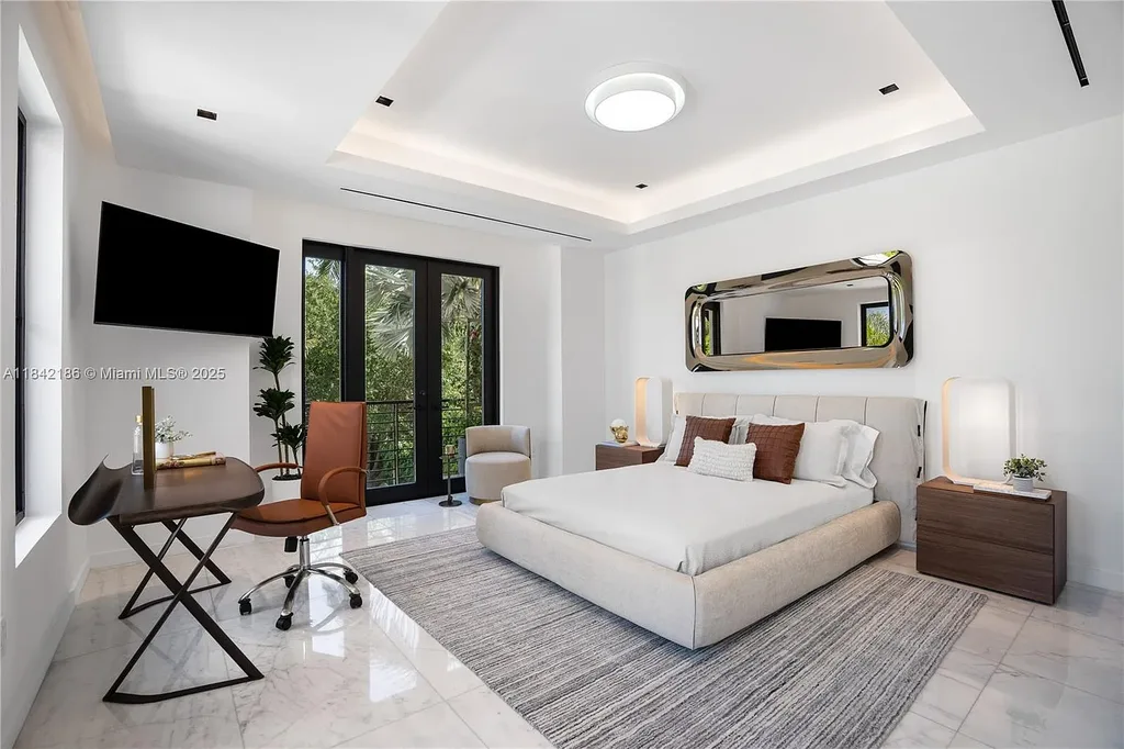 Luxurious waterfront home at 4241 Palm Ln in Miami featuring private dock, infinity-edge pool, modern tropical architecture, and lush Ipe wood deck