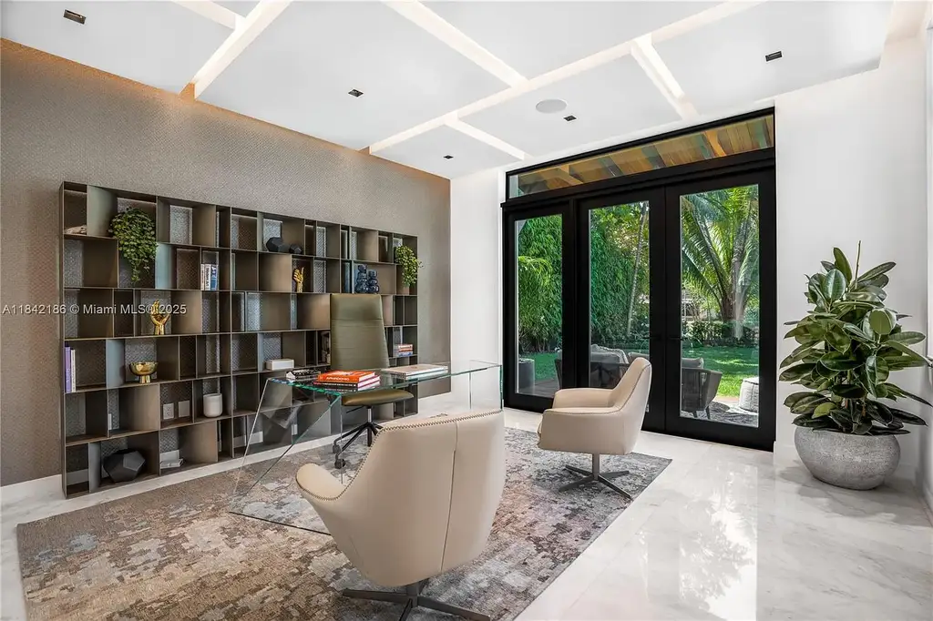 Luxurious waterfront home at 4241 Palm Ln in Miami featuring private dock, infinity-edge pool, modern tropical architecture, and lush Ipe wood deck