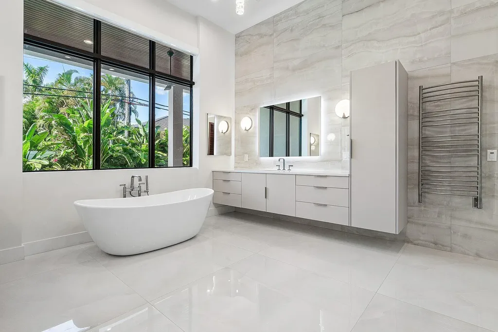 Modern living room inside 450 NE 10th Street featuring soaring ceilings, impact glass, and remote-control fireplace