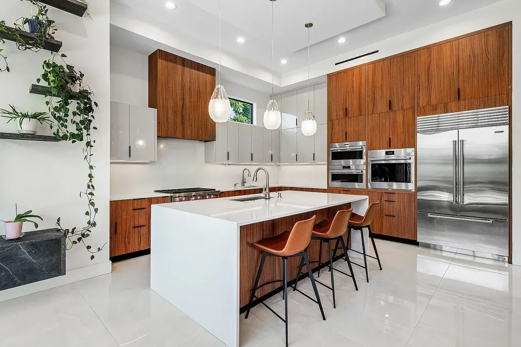 Modern living room inside 450 NE 10th Street featuring soaring ceilings, impact glass, and remote-control fireplace