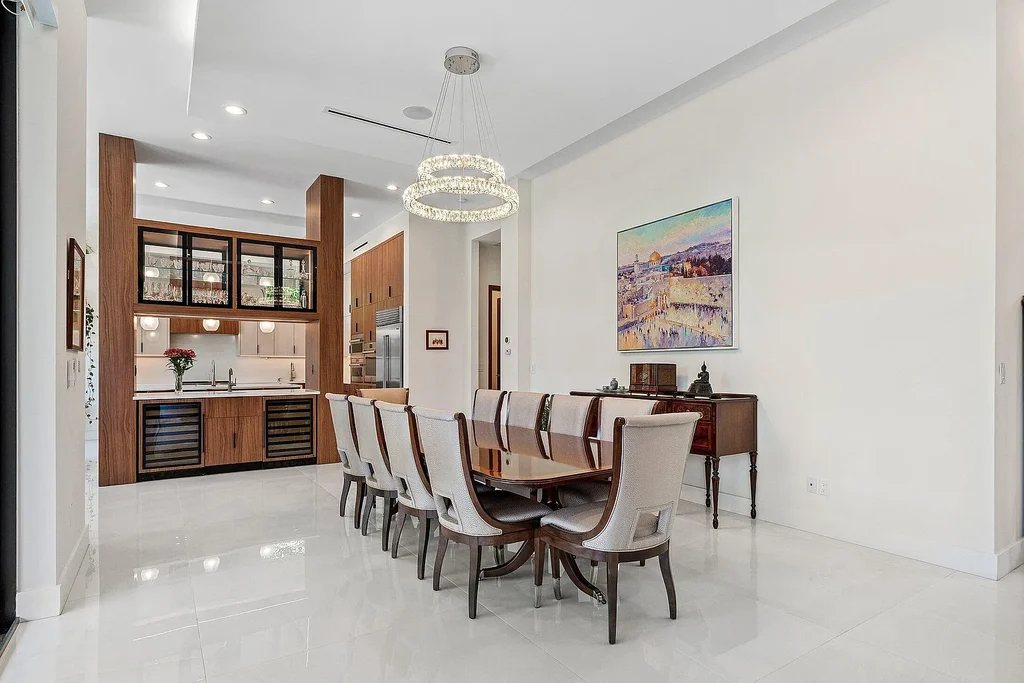 Modern living room inside 450 NE 10th Street featuring soaring ceilings, impact glass, and remote-control fireplace