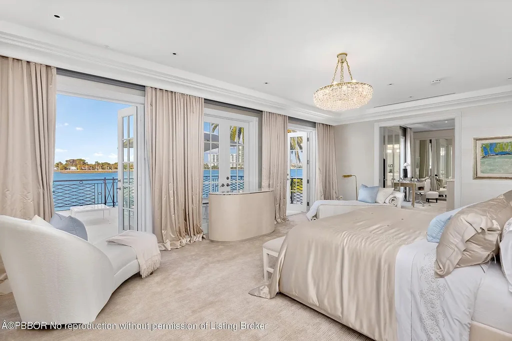 Aerial view of 631 Island Dr in Palm Beach, showcasing Georgian-style architecture, lush landscape, private dock, and direct Intracoastal frontage