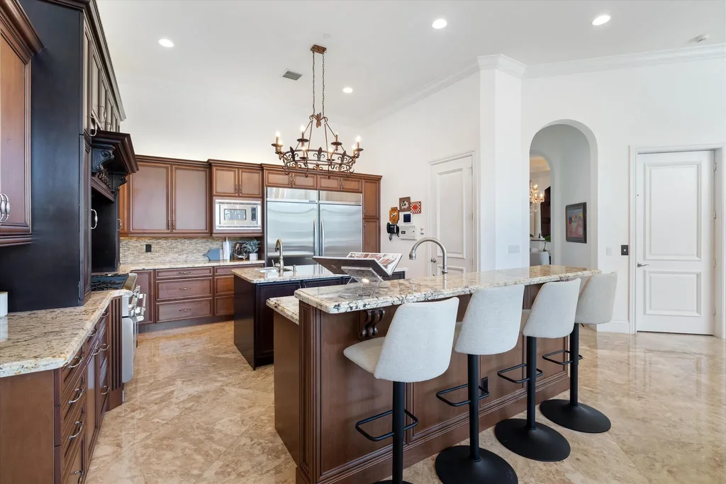 Spacious living room with marble floors and canal views at 932 Banyan Drive