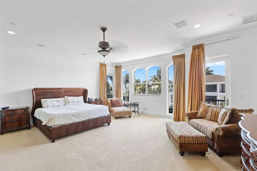 Spacious living room with marble floors and canal views at 932 Banyan Drive