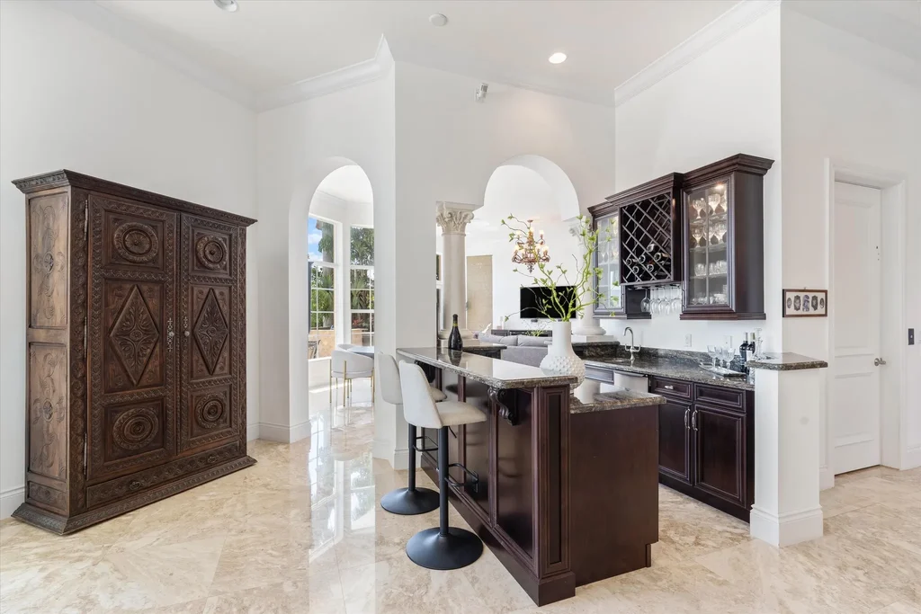 Spacious living room with marble floors and canal views at 932 Banyan Drive