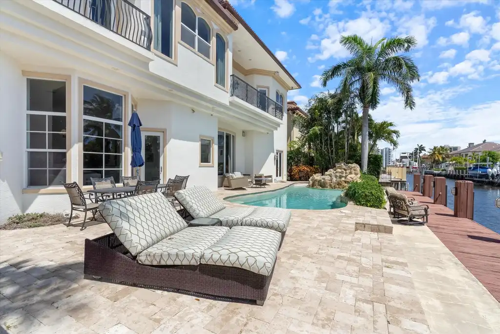 Spacious living room with marble floors and canal views at 932 Banyan Drive