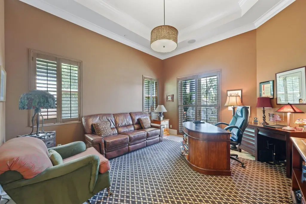 Spacious living room with marble floors and canal views at 932 Banyan Drive