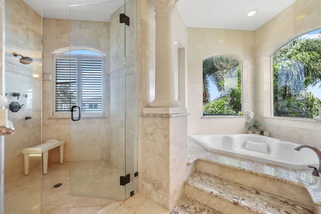 Spacious living room with marble floors and canal views at 932 Banyan Drive