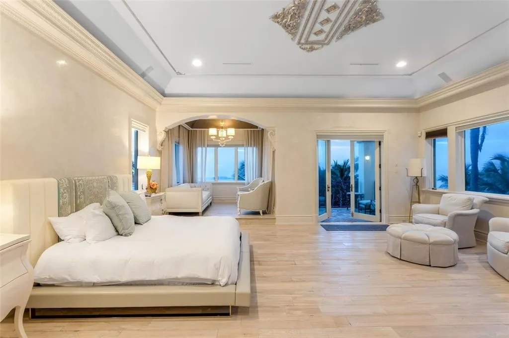 Elegant living room at 2306 Bay Dr featuring marble floors, high ceilings, and panoramic ocean views