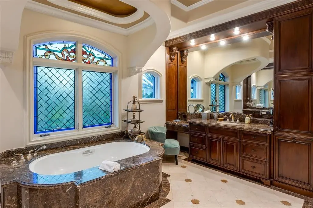 Elegant living room at 2306 Bay Dr featuring marble floors, high ceilings, and panoramic ocean views