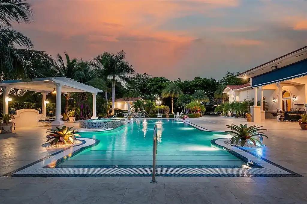 Luxury Mediterranean villa at 5801 Estates Dr in Southwest Ranches featuring resort-style saltwater pool, tropical gardens, and elegant architecture