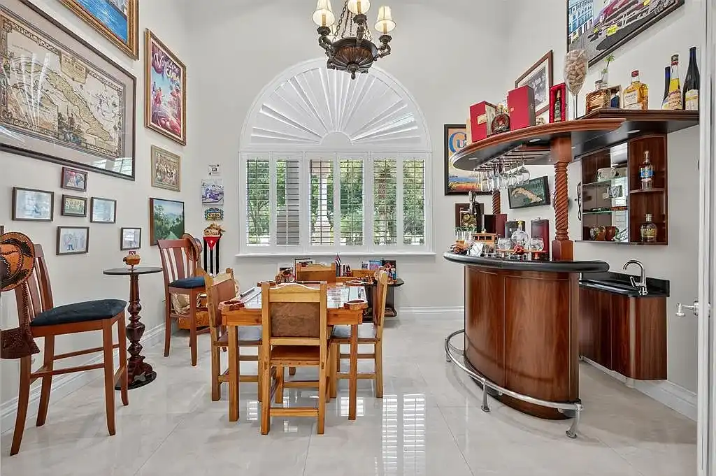 Luxury Mediterranean villa at 5801 Estates Dr in Southwest Ranches featuring resort-style saltwater pool, tropical gardens, and elegant architecture