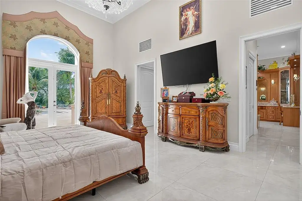 Luxury Mediterranean villa at 5801 Estates Dr in Southwest Ranches featuring resort-style saltwater pool, tropical gardens, and elegant architecture