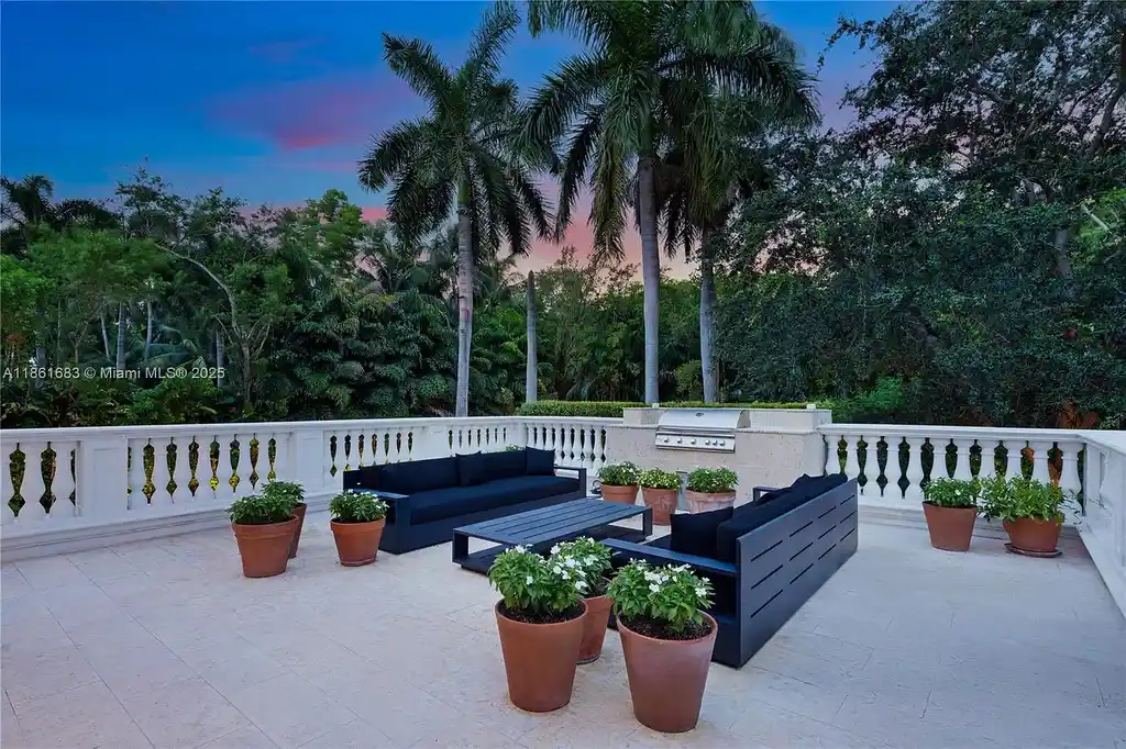 Luxury waterfront estate at 26 Tahiti Beach Island Rd in Coral Gables, FL featuring 6 bedrooms, 9,440 sq ft, private pool, and resort-style amenities.