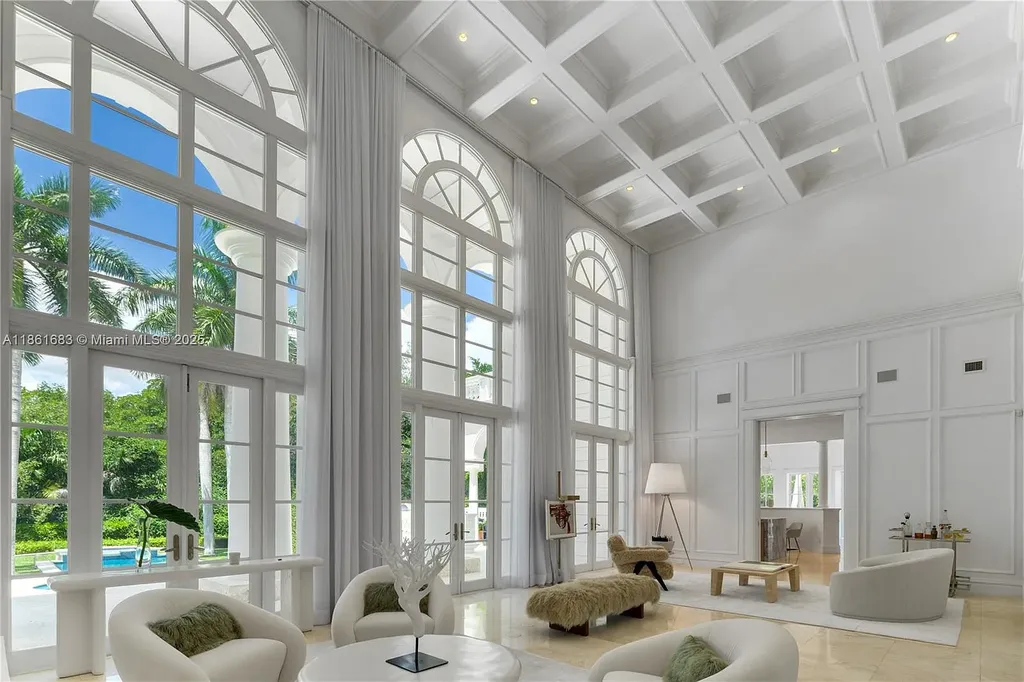 Luxury waterfront estate at 26 Tahiti Beach Island Rd in Coral Gables, FL featuring 6 bedrooms, 9,440 sq ft, private pool, and resort-style amenities.