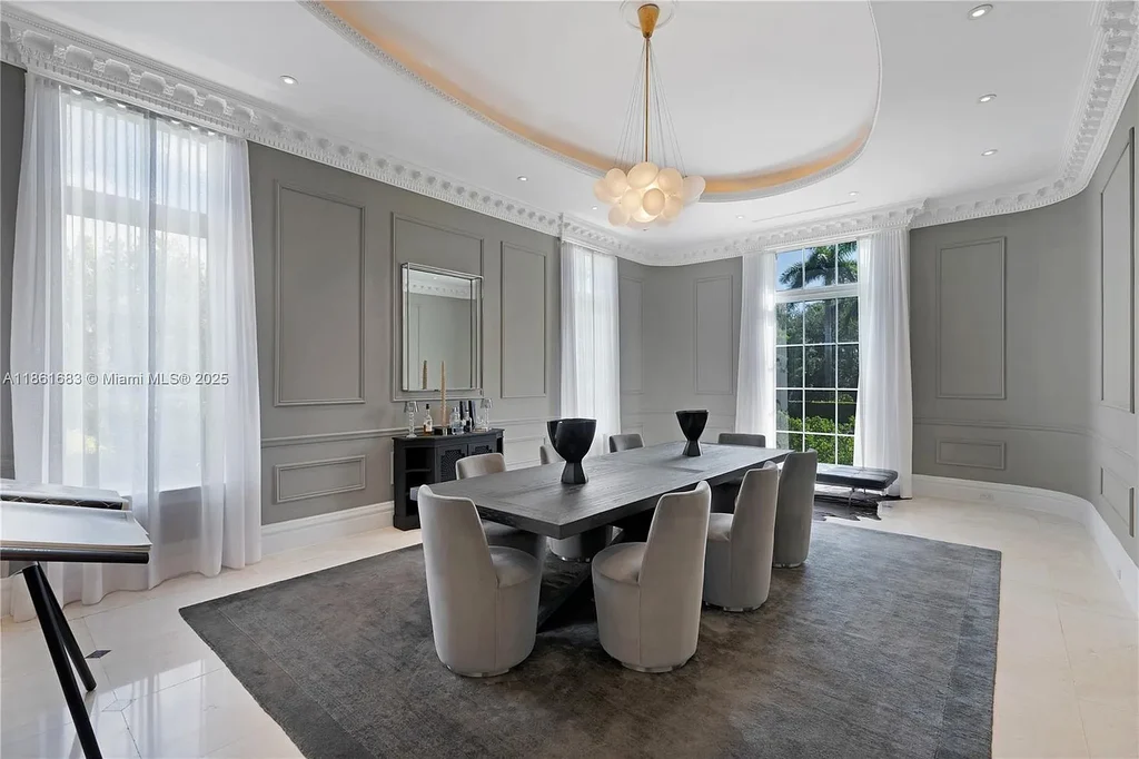 Luxury waterfront estate at 26 Tahiti Beach Island Rd in Coral Gables, FL featuring 6 bedrooms, 9,440 sq ft, private pool, and resort-style amenities.