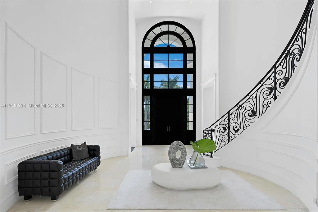 Luxury waterfront estate at 26 Tahiti Beach Island Rd in Coral Gables, FL featuring 6 bedrooms, 9,440 sq ft, private pool, and resort-style amenities.