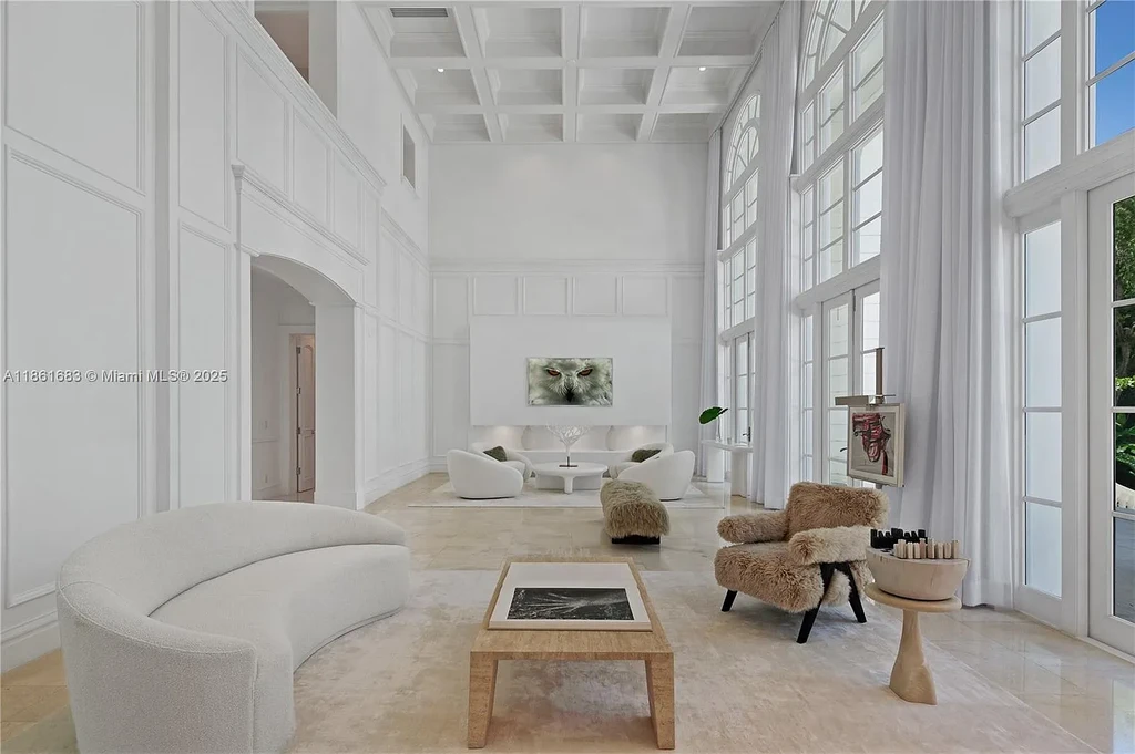 Luxury waterfront estate at 26 Tahiti Beach Island Rd in Coral Gables, FL featuring 6 bedrooms, 9,440 sq ft, private pool, and resort-style amenities.