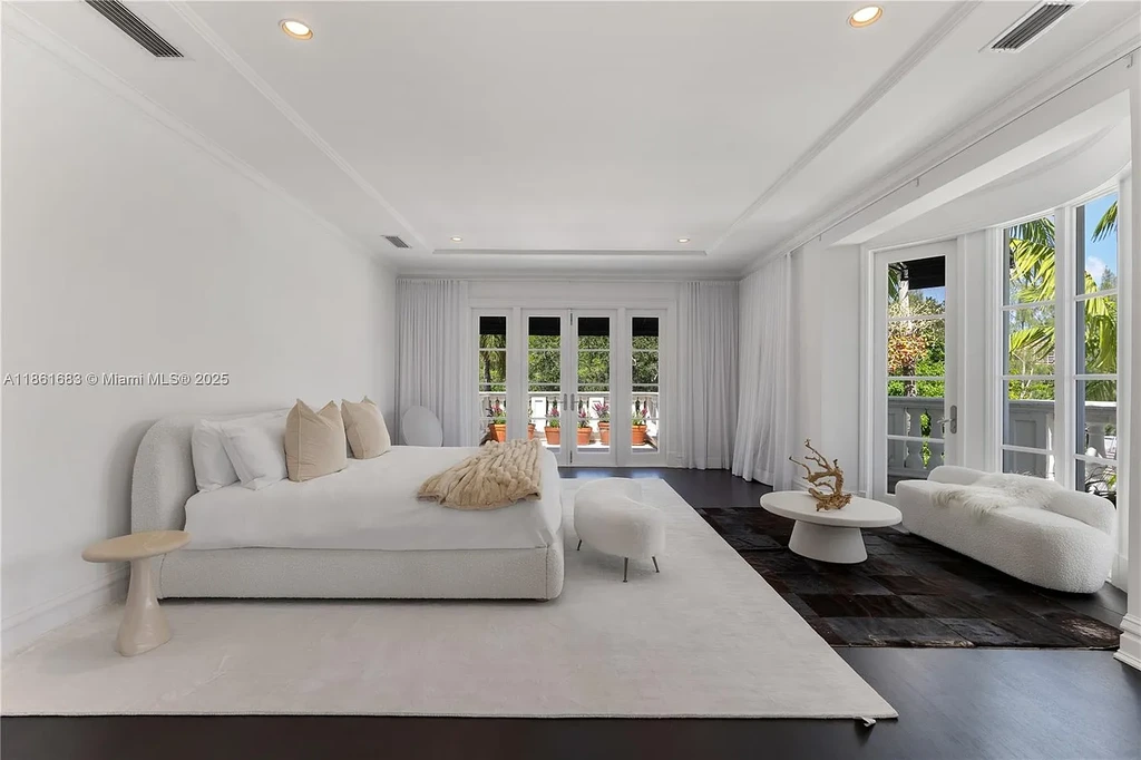 Luxury waterfront estate at 26 Tahiti Beach Island Rd in Coral Gables, FL featuring 6 bedrooms, 9,440 sq ft, private pool, and resort-style amenities.