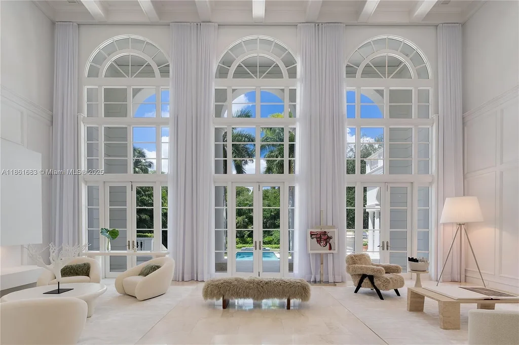 Luxury waterfront estate at 26 Tahiti Beach Island Rd in Coral Gables, FL featuring 6 bedrooms, 9,440 sq ft, private pool, and resort-style amenities.