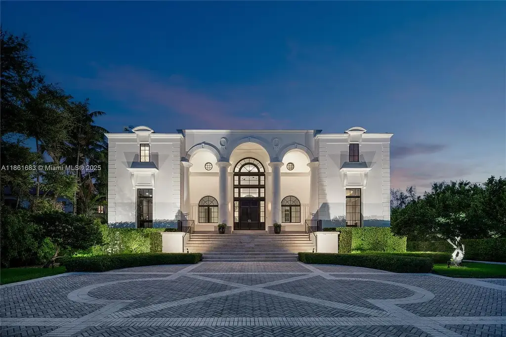 Luxury waterfront estate at 26 Tahiti Beach Island Rd in Coral Gables, FL featuring 6 bedrooms, 9,440 sq ft, private pool, and resort-style amenities.