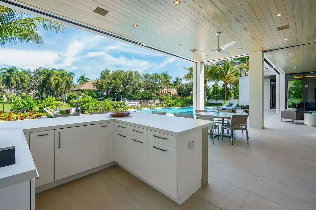 175 W Alexander Palm Road luxury waterfront home for sale in Boca Raton with modern design, private dock, resort-style pool, and Royal Palm Yacht Club location.