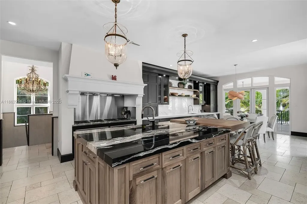 Luxury waterfront estate at 3305 S Moorings Way, Miami, FL 33133 with private dock, pool, 7 bedrooms, 9 bathrooms, and panoramic Biscayne Bay views.