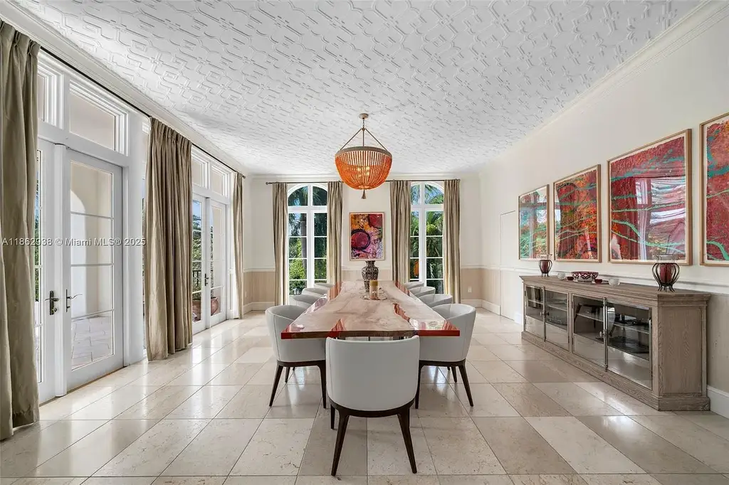 Luxury waterfront estate at 3305 S Moorings Way, Miami, FL 33133 with private dock, pool, 7 bedrooms, 9 bathrooms, and panoramic Biscayne Bay views.