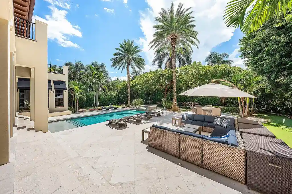 Front exterior of 518 Harbor Court Delray Beach luxury home for sale with European-inspired architecture and lush landscaping