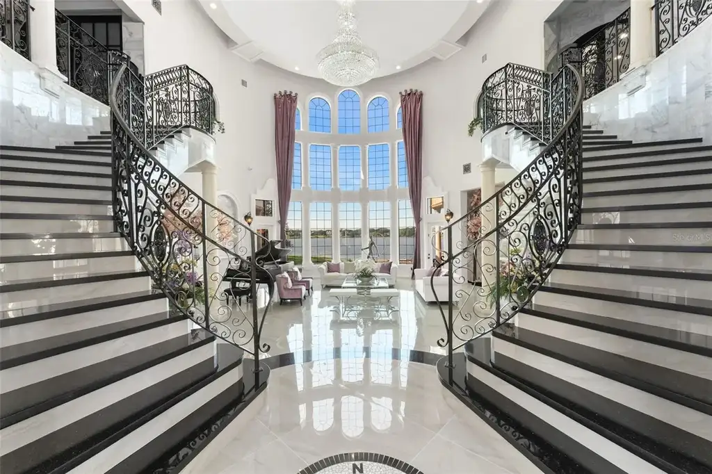 Spacious marble-floor living room with soaring ceilings and lake views inside 9639 Westover Roberts Rd luxury home in Windermere FL
