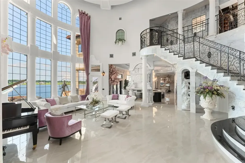 Spacious marble-floor living room with soaring ceilings and lake views inside 9639 Westover Roberts Rd luxury home in Windermere FL