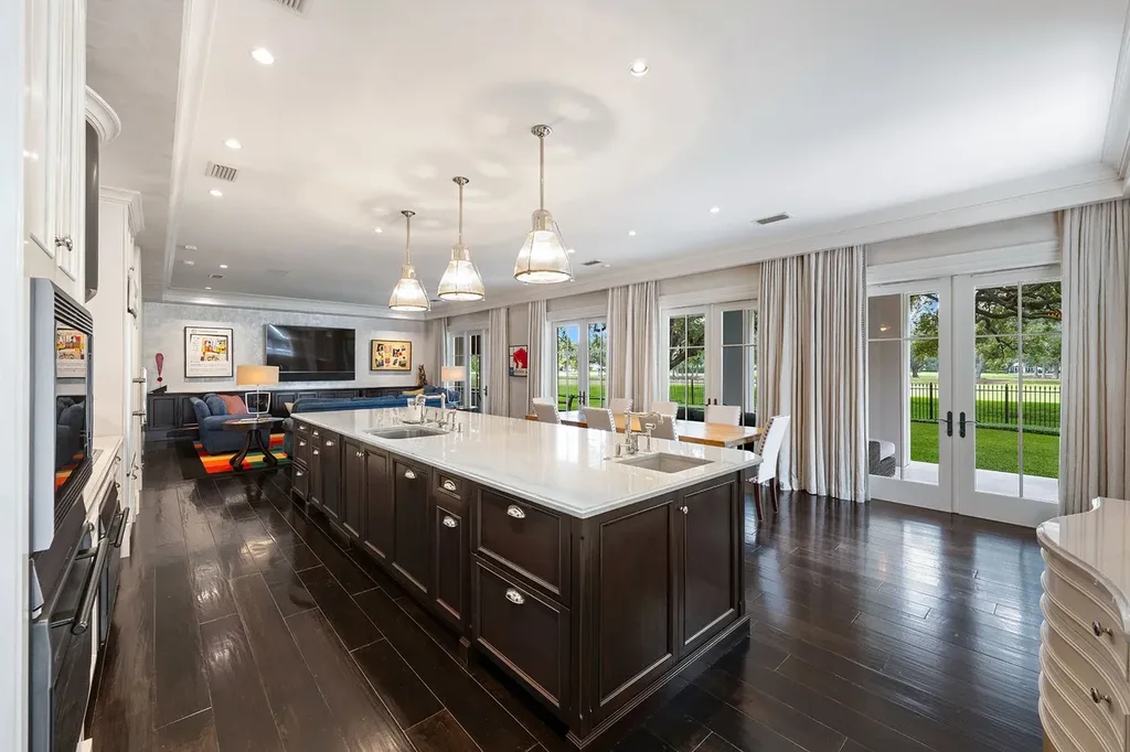 Outdoor living space with heated saltwater pool, cabana, and manicured gardens overlooking golf course